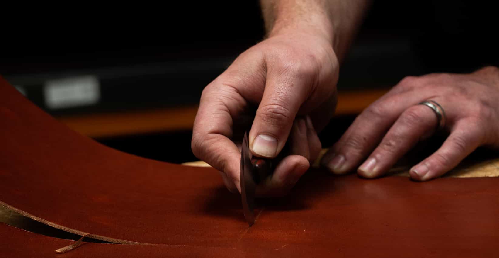 Leather worker cutting leather with Abbey Round Knife
