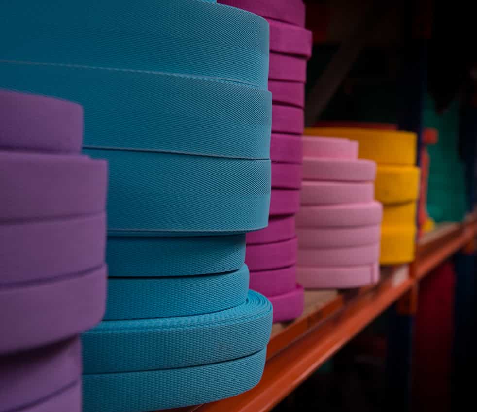 Webbing and tape stacked on shelf.