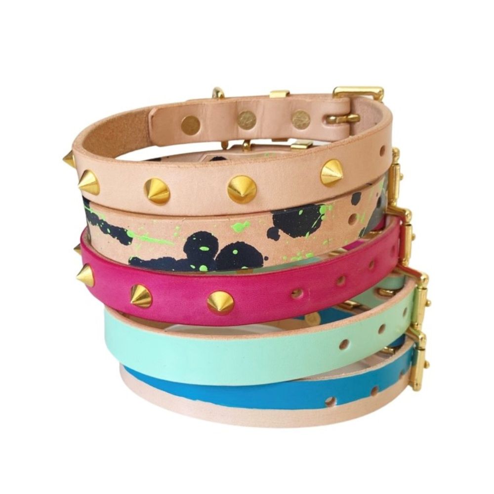 Stack of dog collars with painted designs and studs
